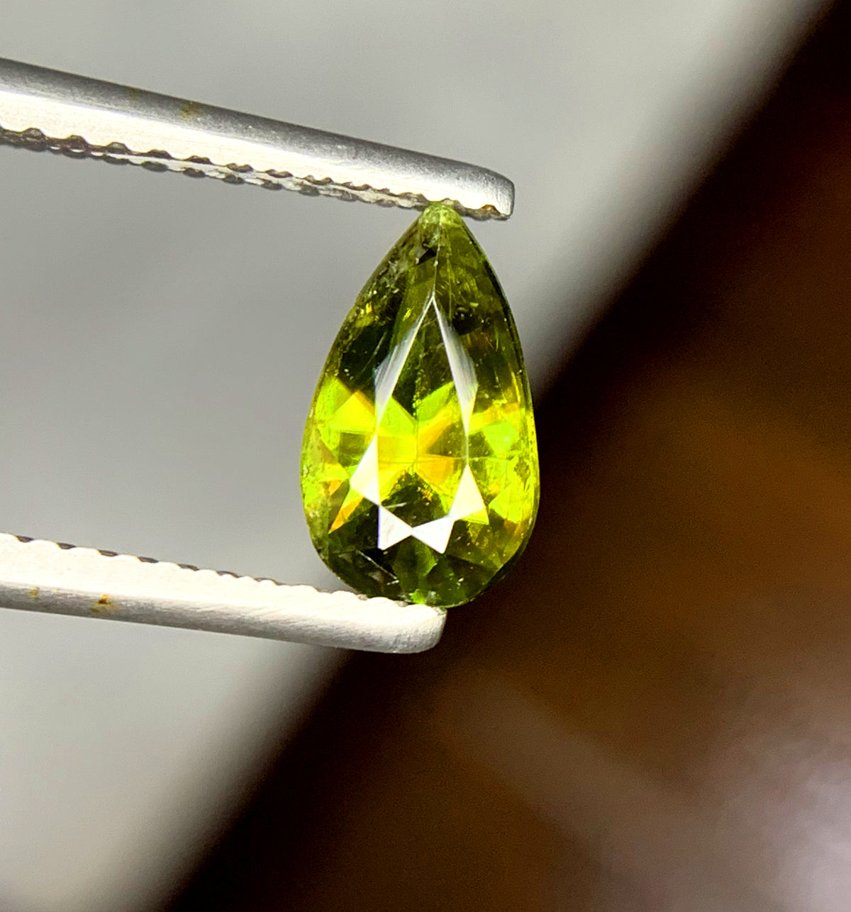 Facets along the crown of a slim pear sphene
Loose green sphene shaped for drop earrings