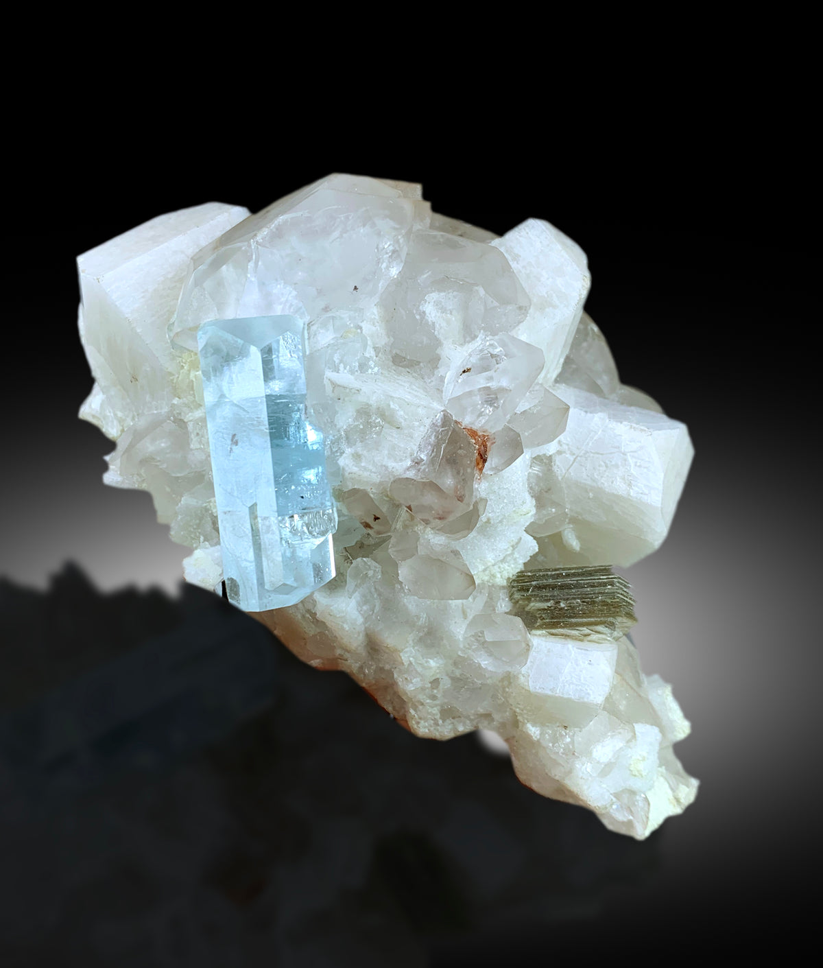 Aquamarine specimen self standing back angle view
Blue and black color contrast on aquamarine specimen
Microcline feldspar crystal detail on specimen