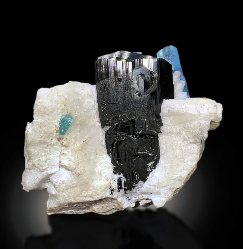 Blue and black color contrast on aquamarine specimen
Aquamarine crystal fixed on clear acrylic display base