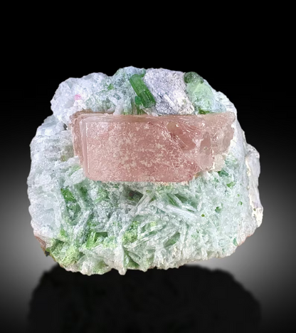 Closeup of morganite crystal color and luster
Pink morganite with green tourmaline side view