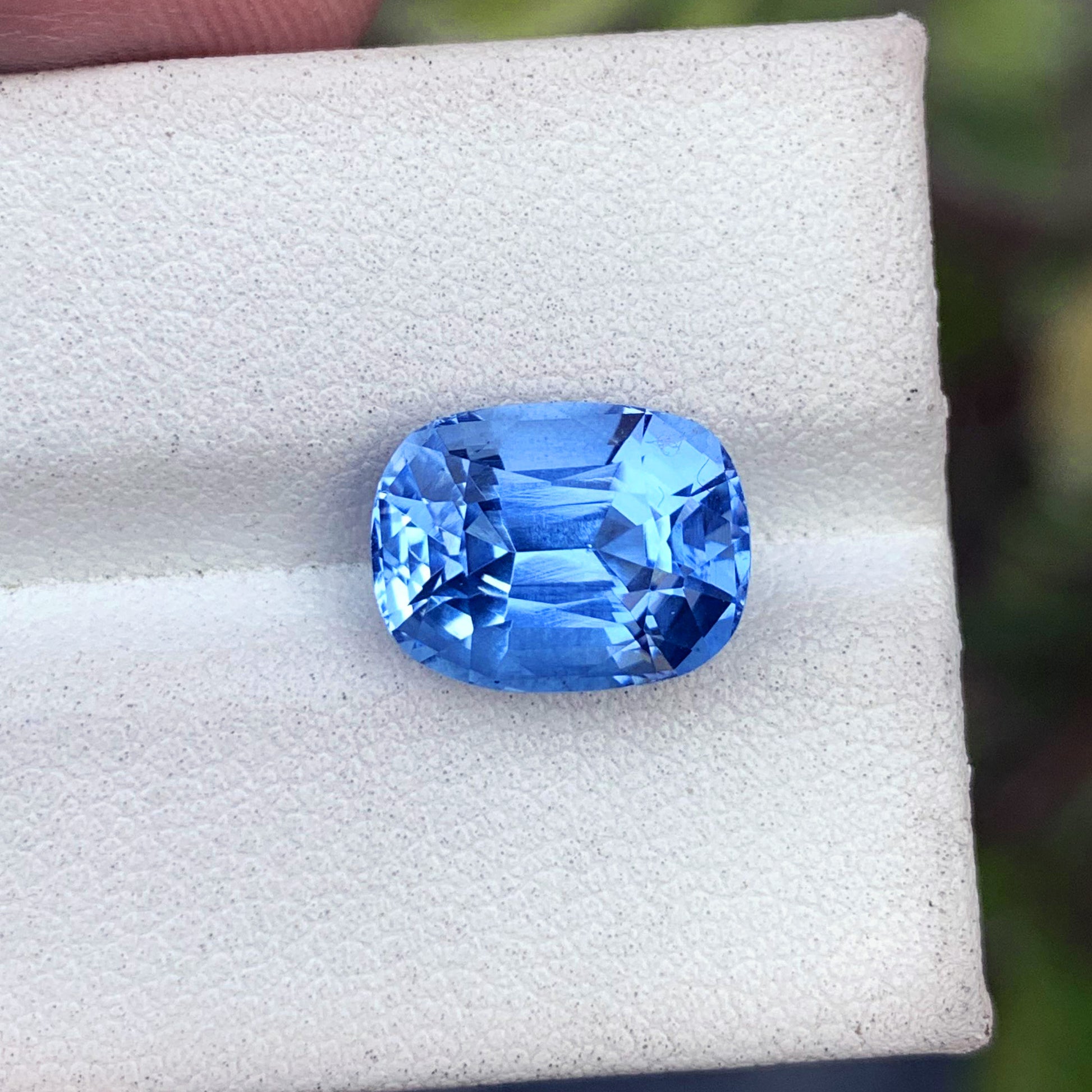 Deep blue aquamarine faceted gemstone close-up
Long cushion aquamarine loose stone 12x9mm