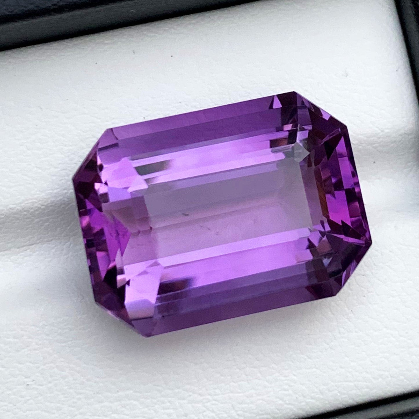 Emerald cut faceted crown detail on amethyst
Full profile of purple amethyst loose stone