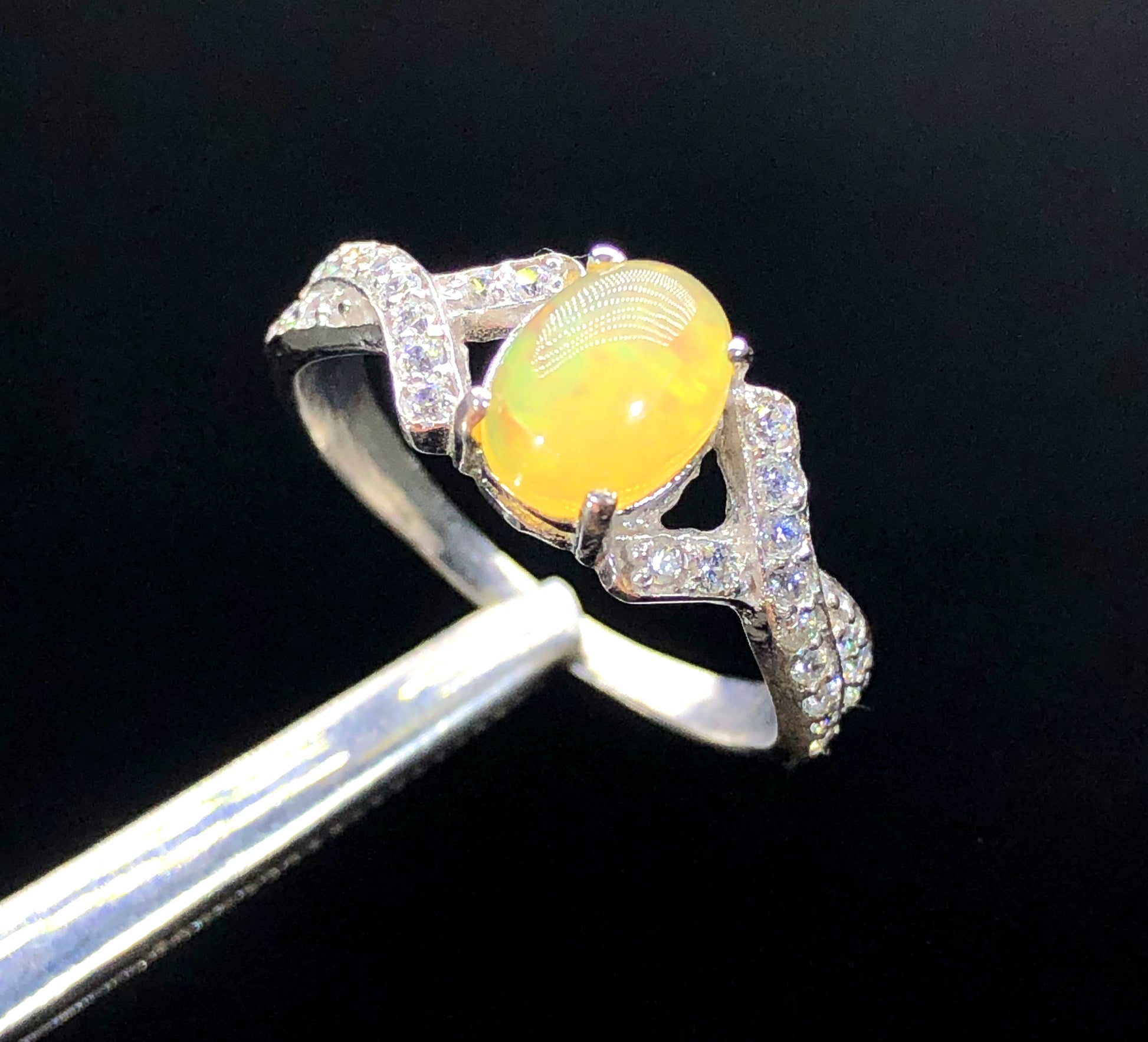 Ethiopian Welo opal ring play-of-color with zircon accents
Natural opal and zircon ring 25x21mm centerpiece