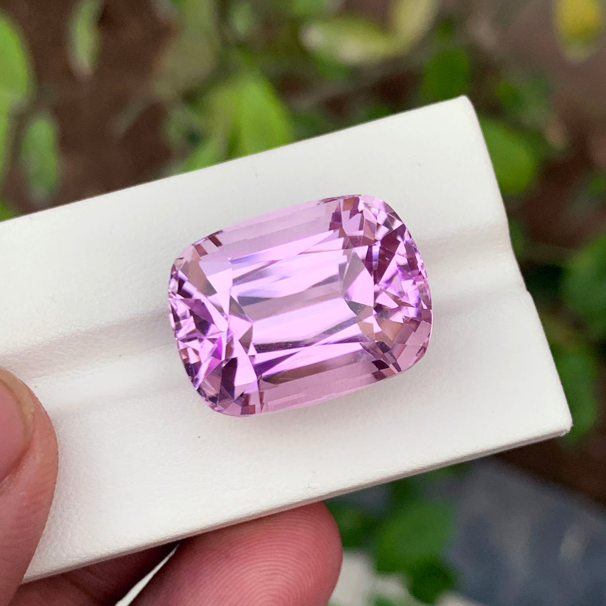 Full profile of lilac pink kunzite loose stone
Kunzite gemstone facets showing flawless clarity