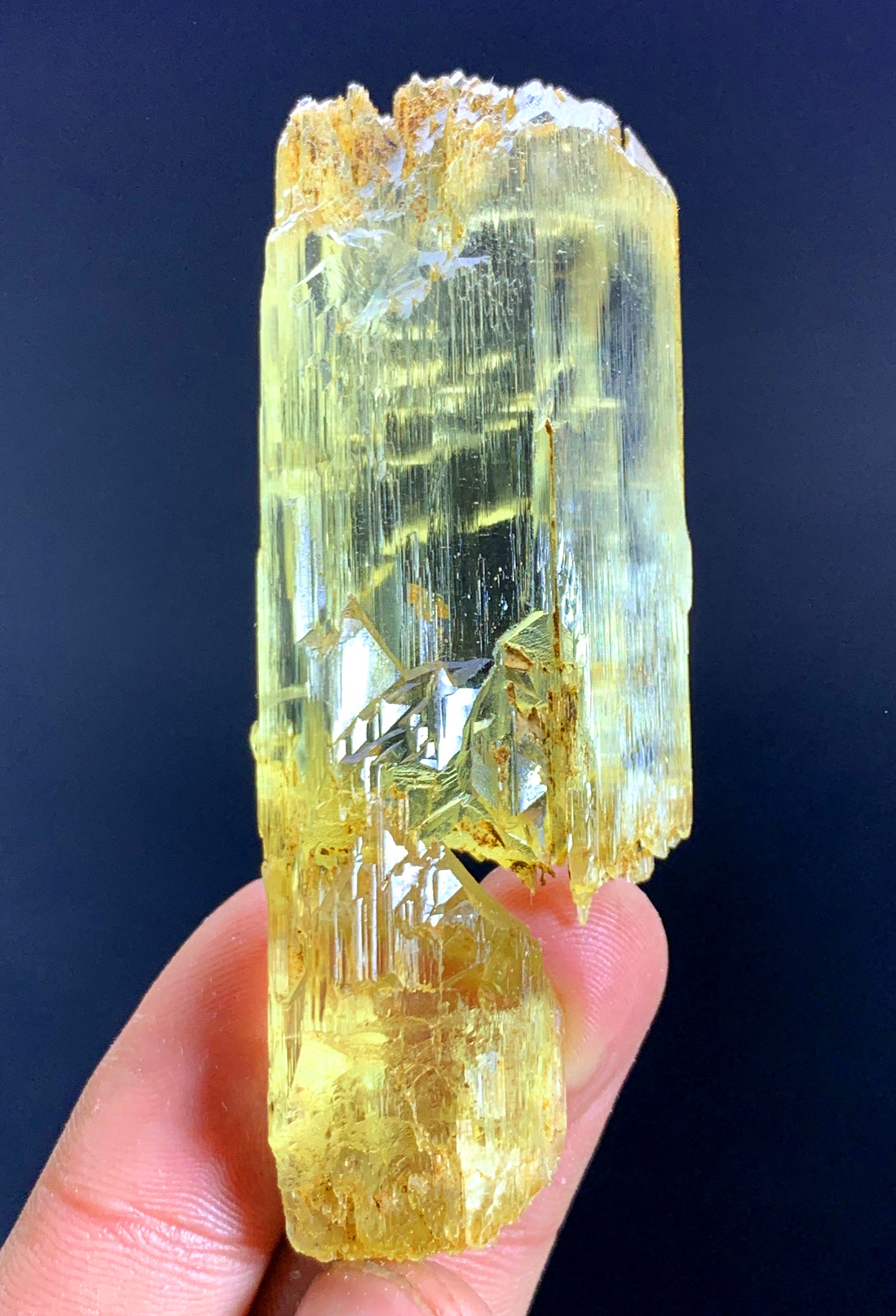 Full profile of prismatic yellow kunzite crystal
Triphane crystal faces showing luster along length