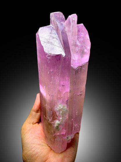 Full profile of raw pink kunzite mineral
Kunzite crystal faces showing glassy luster