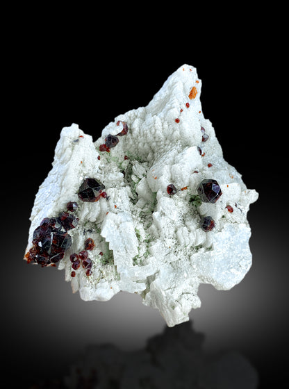Raw red garnet mineral specimen for collectors
Garnet crystal cluster on matrix, close-up detail