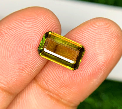 Green sphene gemstone, step facet view
Natural emerald cut sphene, angled view
2.35 carat green sphene, full view