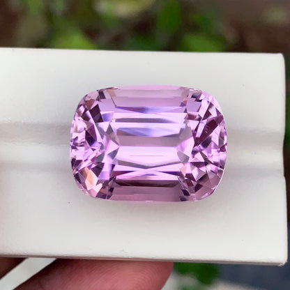 Kunzite gemstone with scale reference for size
Cushion cut faceted crown detail on kunzite