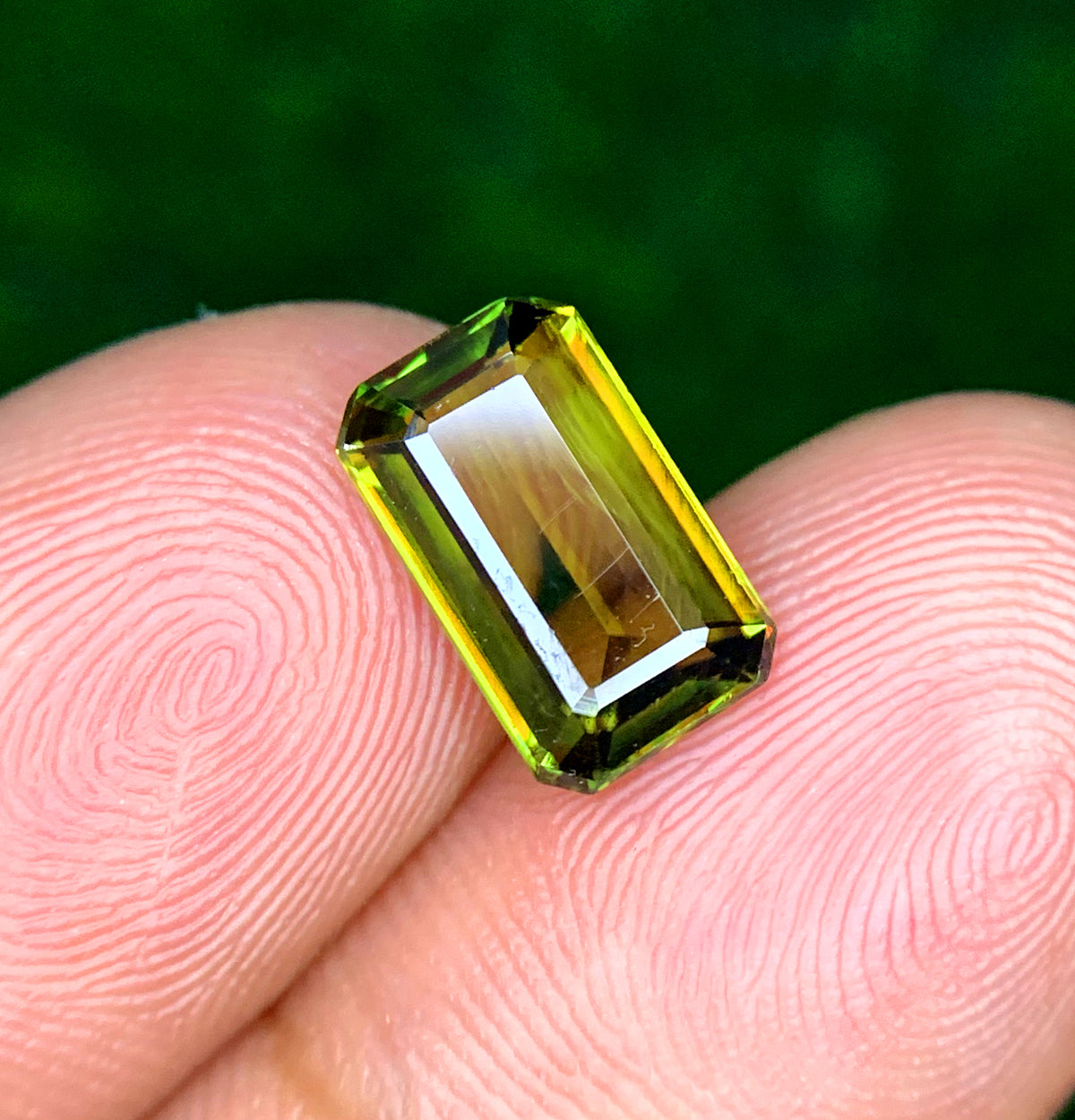 Loose emerald cut sphene gemstone, front view
Natural green titanite, side profile
Emerald cut sphene, corner detail
