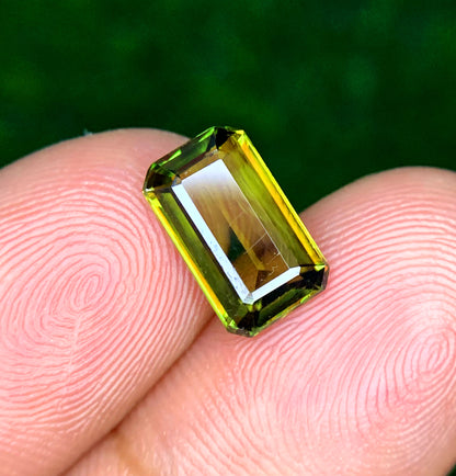 Loose emerald cut sphene gemstone, front view
Natural green titanite, side profile
Emerald cut sphene, corner detail