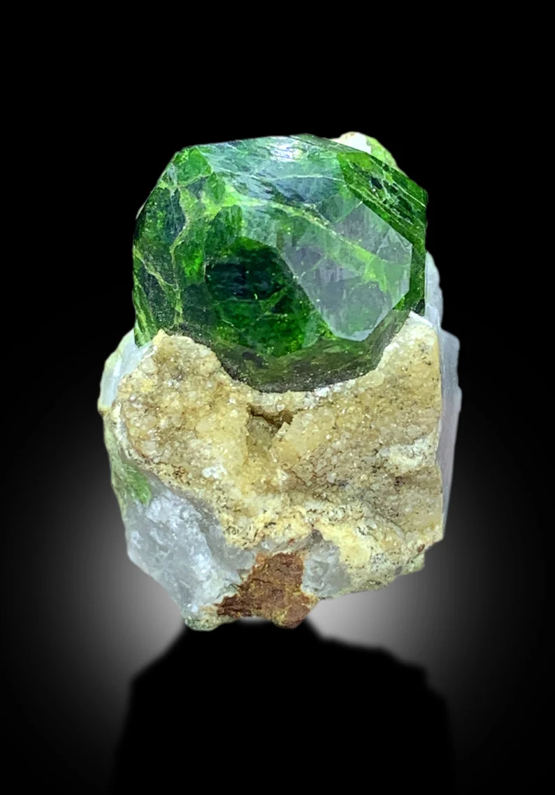 Lush green color detail on demantoid garnet
Self standing garnet crystal on calcite base
Collector grade demantoid garnet from Afghanistan