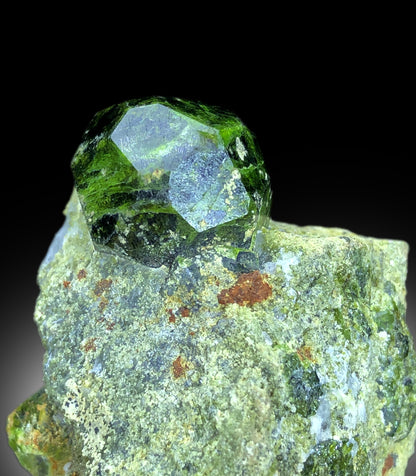 Lush green color detail on demantoid garnet crystal
Raw demantoid garnet crystal on natural matrix base