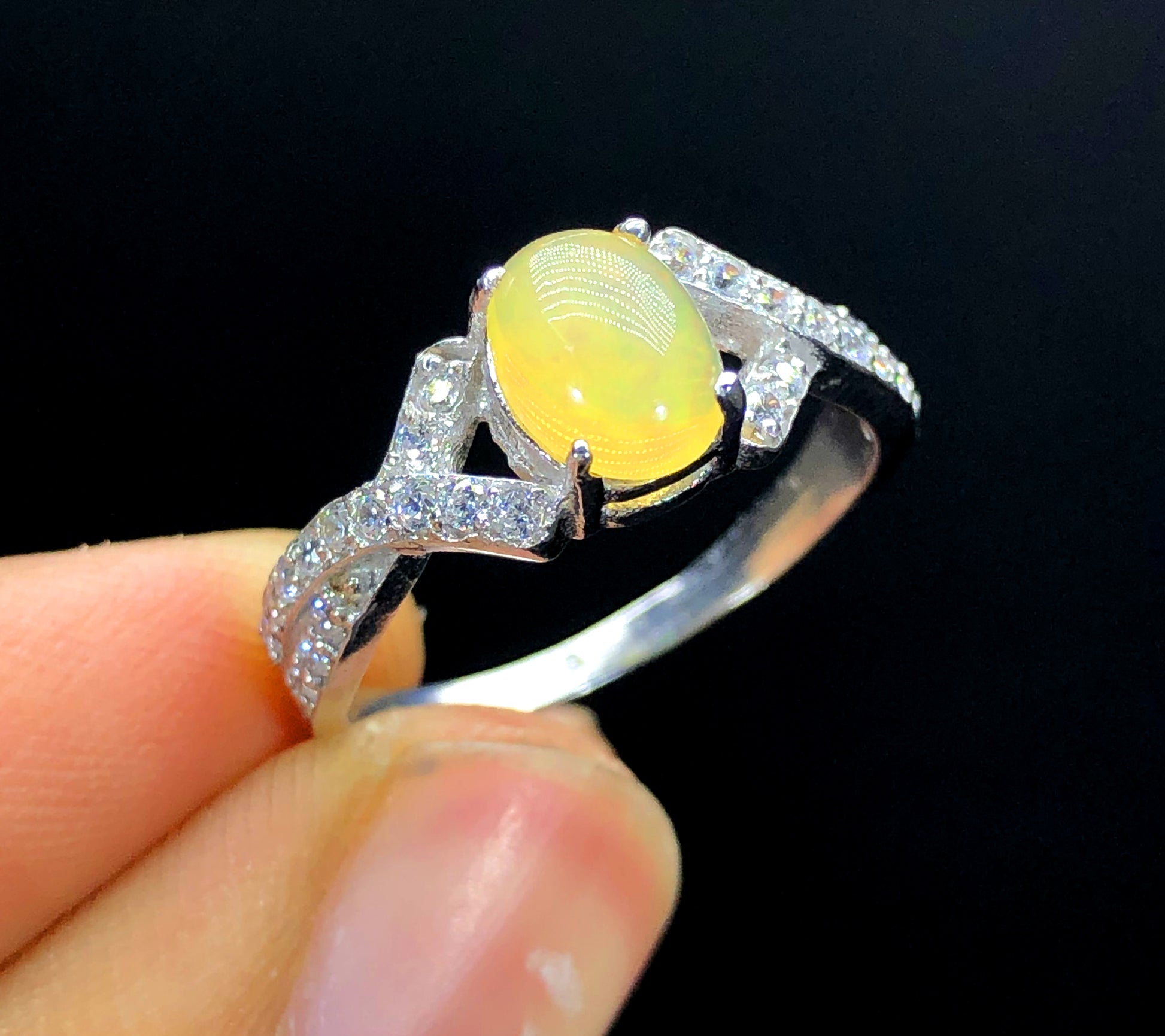 Natural opal zircon ring showing rainbow color shift
Handmade opal ring Ethiopia white band close-up
October birthstone opal ring with zircon accents
Natural Ethiopian opal ring gift for her