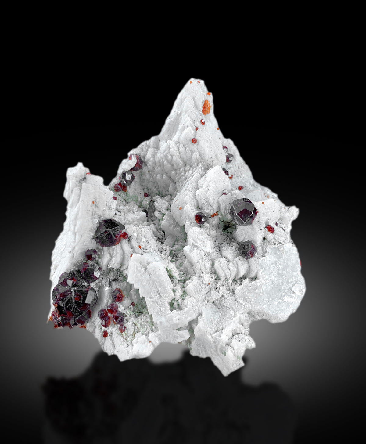 Natural garnet crystals with strong color and luster on matrix