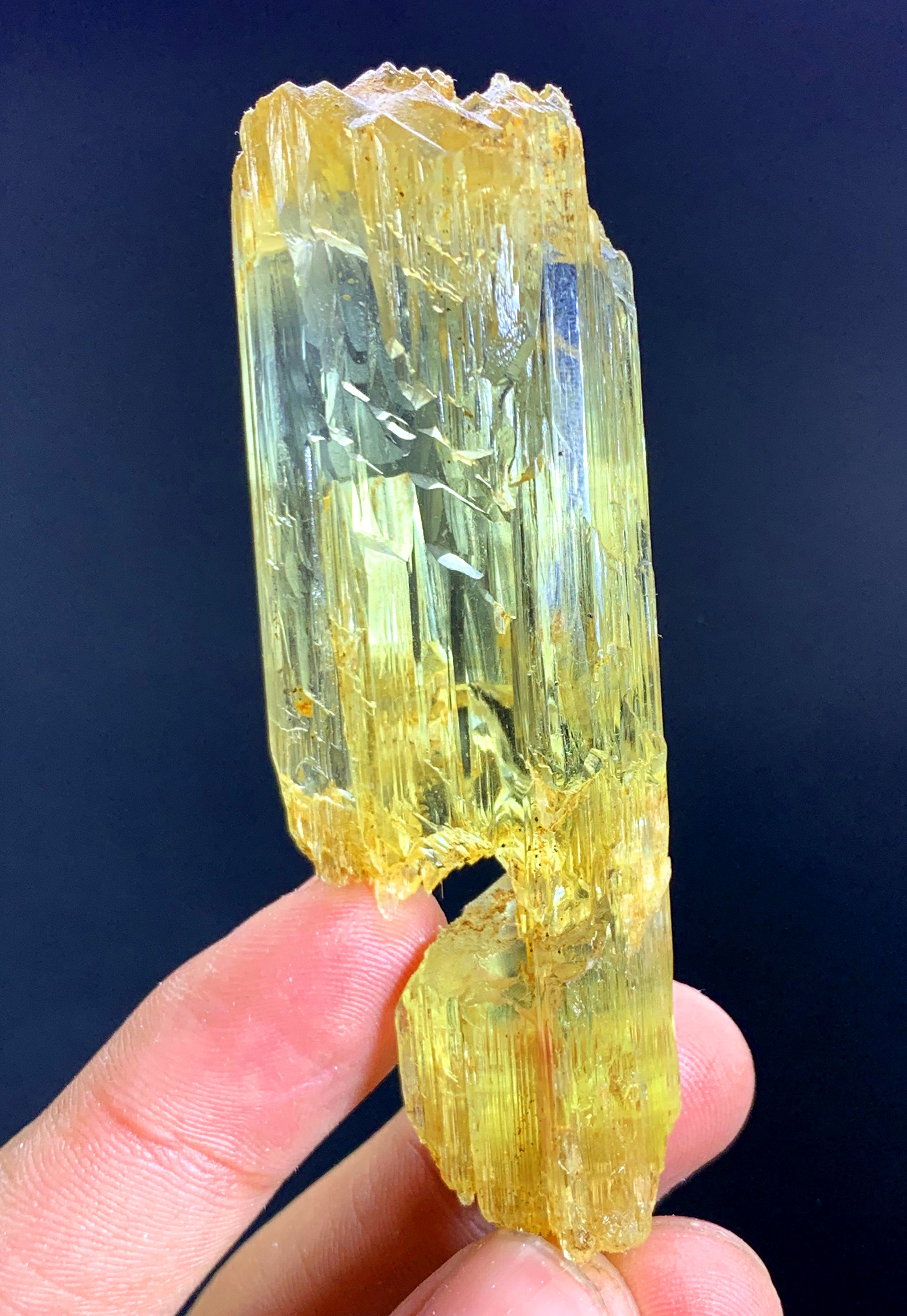 Natural mountain shape termination on long crystal
Elongated yellow triphane specimen full length view