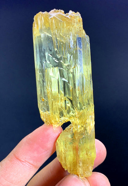 Natural mountain shape termination on long crystal
Elongated yellow triphane specimen full length view