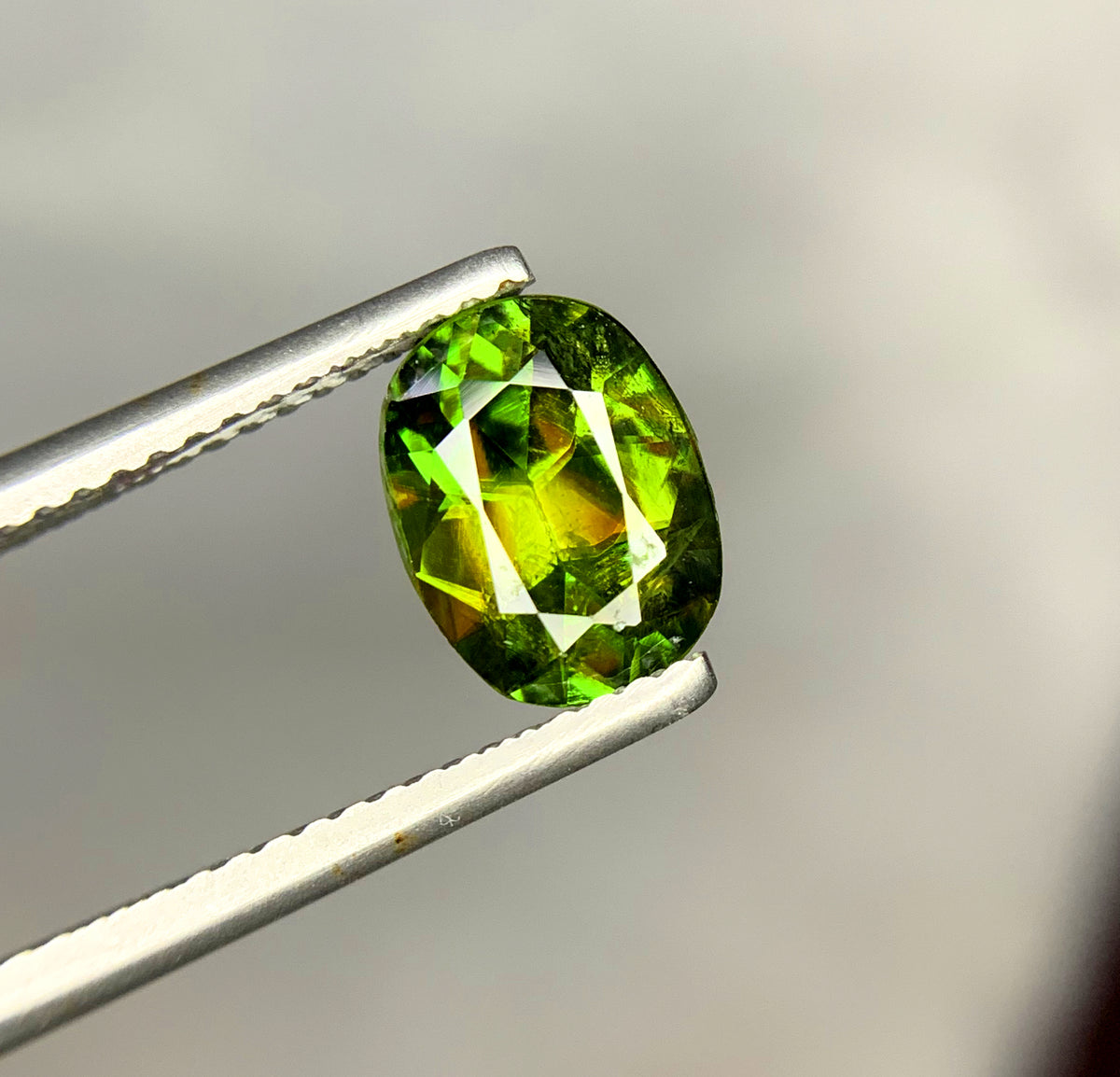 Green sphene gemstone, faceted view
Natural oval cut sphene, angled view
1.80 carat green sphene, full view