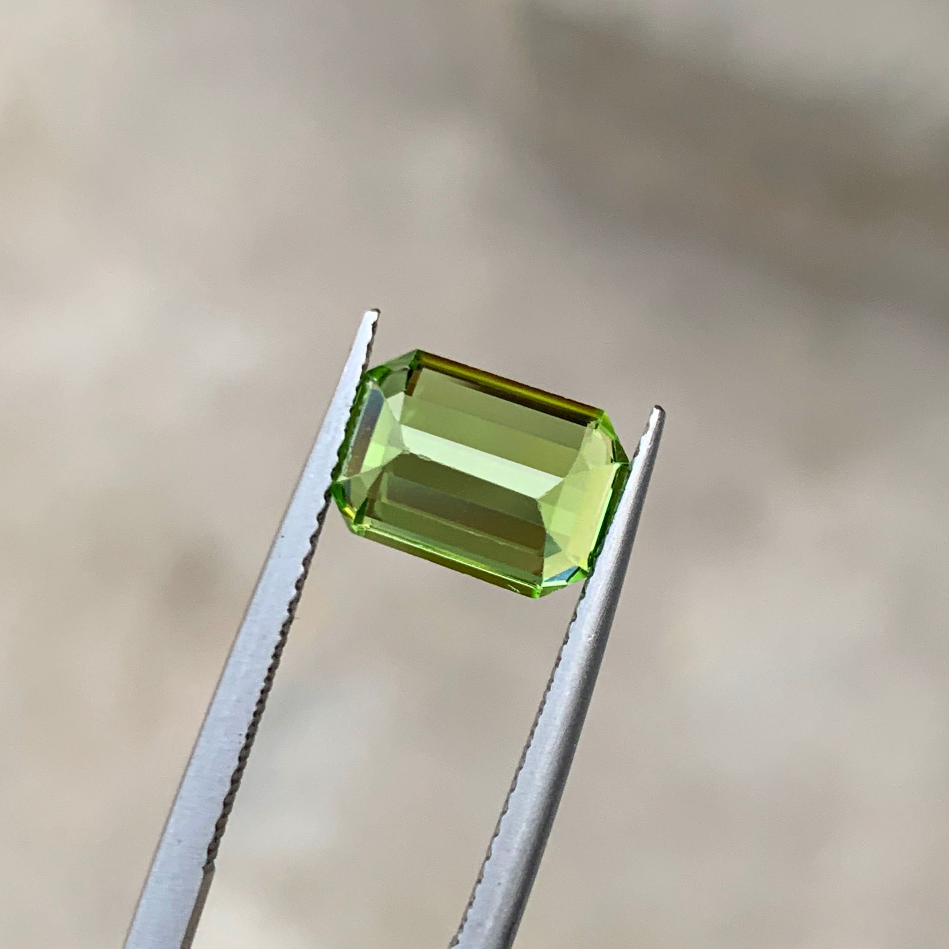 Natural untreated peridot apple green color close-up
Peridot emerald cut showing vivid apple green depth