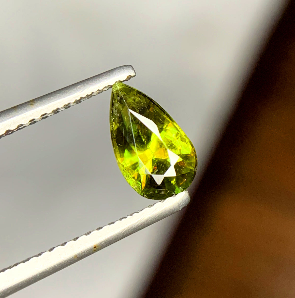 Pavilion side of a narrow pear cut green sphene
Green titanite pear, 9 x 5 x 4 mm
One carat sphene showing its 5 mm width
