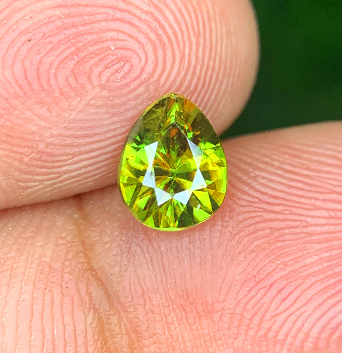 Loose pear cut sphene, 7x6x4mm
Natural green sphene, side profile
Pear shaped titanite gemstone, top view
Fire sphene, faceted detail