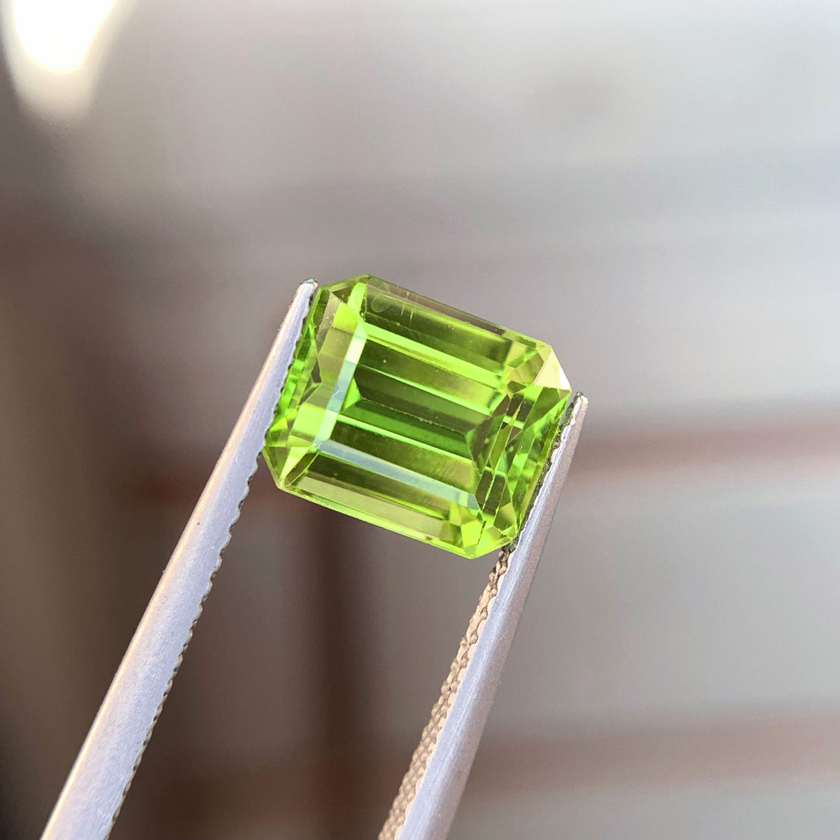 Peridot gemstone, August birthstone, emerald faceted cut
Burma peridot stone, front angle view