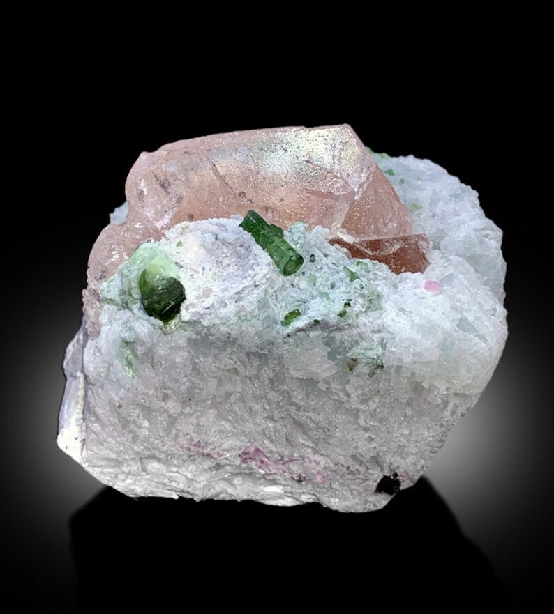Pink morganite color detail on crystal face
Raw mineral morganite crystal on albite base
Collector grade morganite specimen from Pakistan
Morganite and tourmaline crystal lighting detail