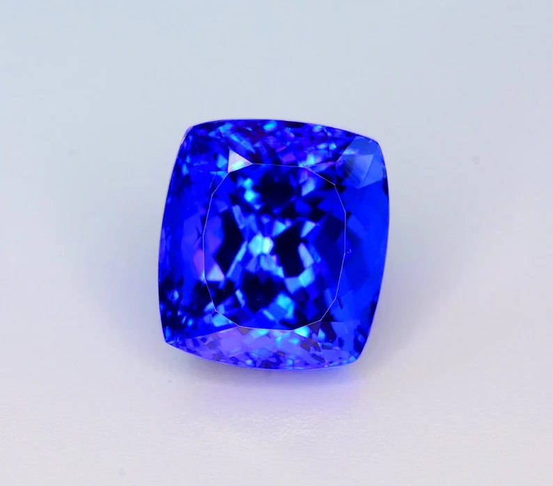 Tanzanite gemstone with scale reference for size
Princess cut faceted crown detail on tanzanite