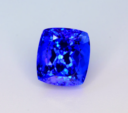 Tanzanite gemstone with scale reference for size
Princess cut faceted crown detail on tanzanite