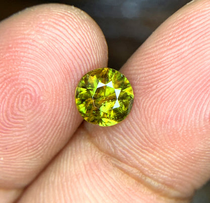 Sphene gemstone, March birthstone, round faceted cut
Fire sphene stone, front angle view
Natural titanite sphene gemstone, side profile
Round cut sphene gemstone, 0.95 carat, top view
