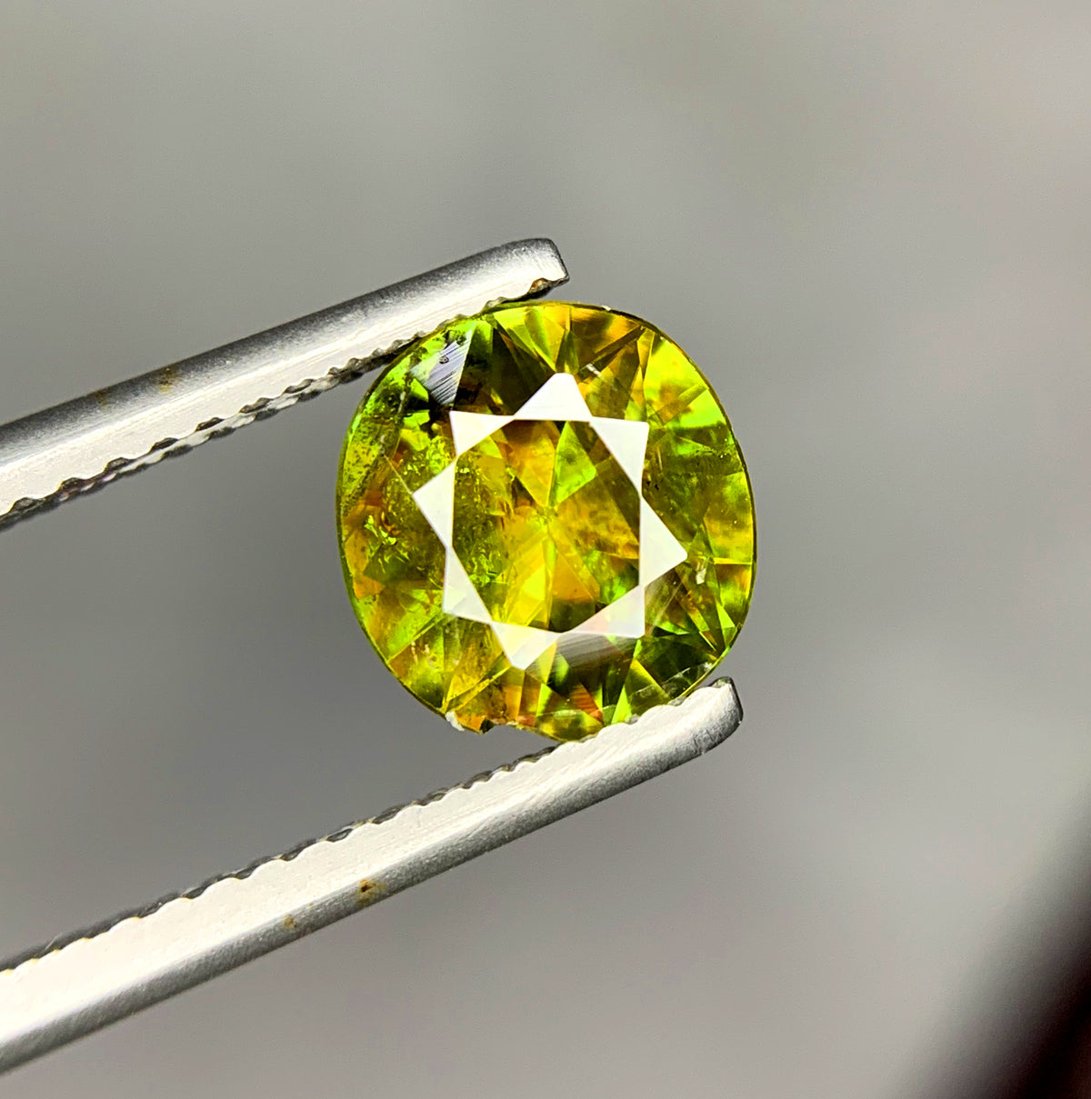 Side profile of a 4.5 mm deep round sphene
Pavilion view of a loose round cut green sphene