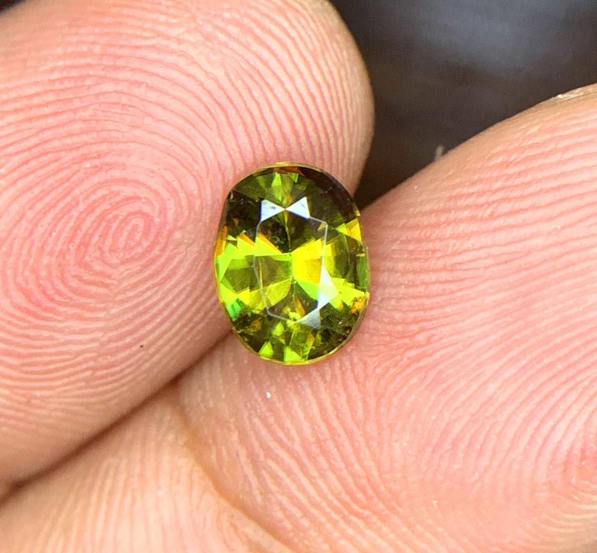 Sphene gemstone, March birthstone, oval faceted cut
Full fire sphene stone, front angle view
Natural titanite sphene gemstone, side profile
Oval cut sphene gemstone, 1.10 carat, top view