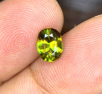 Sphene gemstone, March birthstone, oval faceted cut
Full fire sphene stone, front angle view
Natural titanite sphene gemstone, side profile
Oval cut sphene gemstone, 1.10 carat, top view