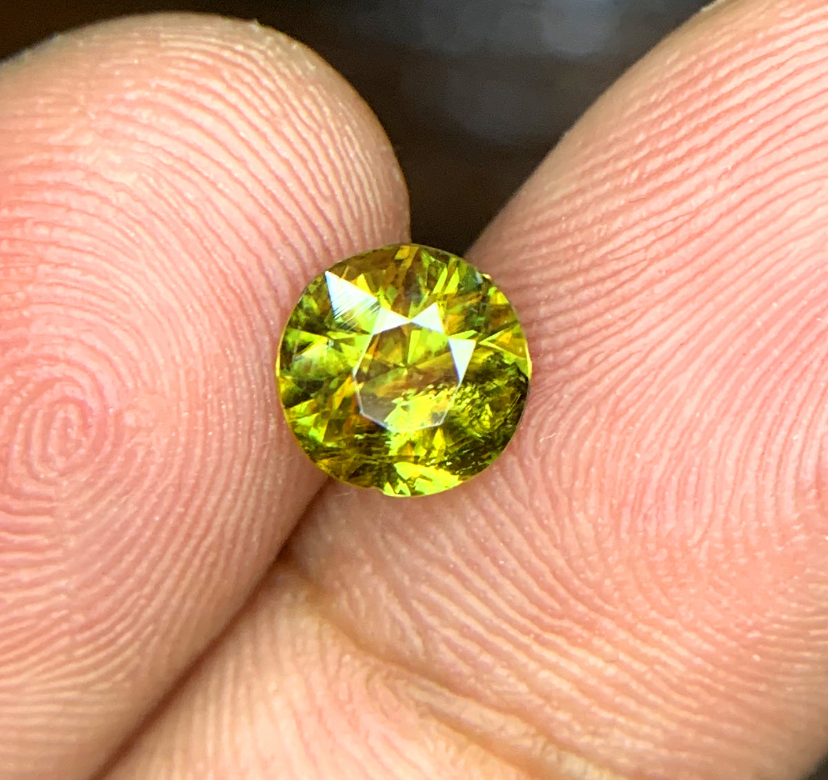 Sphene gemstone, March birthstone, round faceted cut
Fire sphene stone, front angle view
Natural titanite sphene gemstone, side profile
Round cut sphene gemstone, 0.95 carat, top view