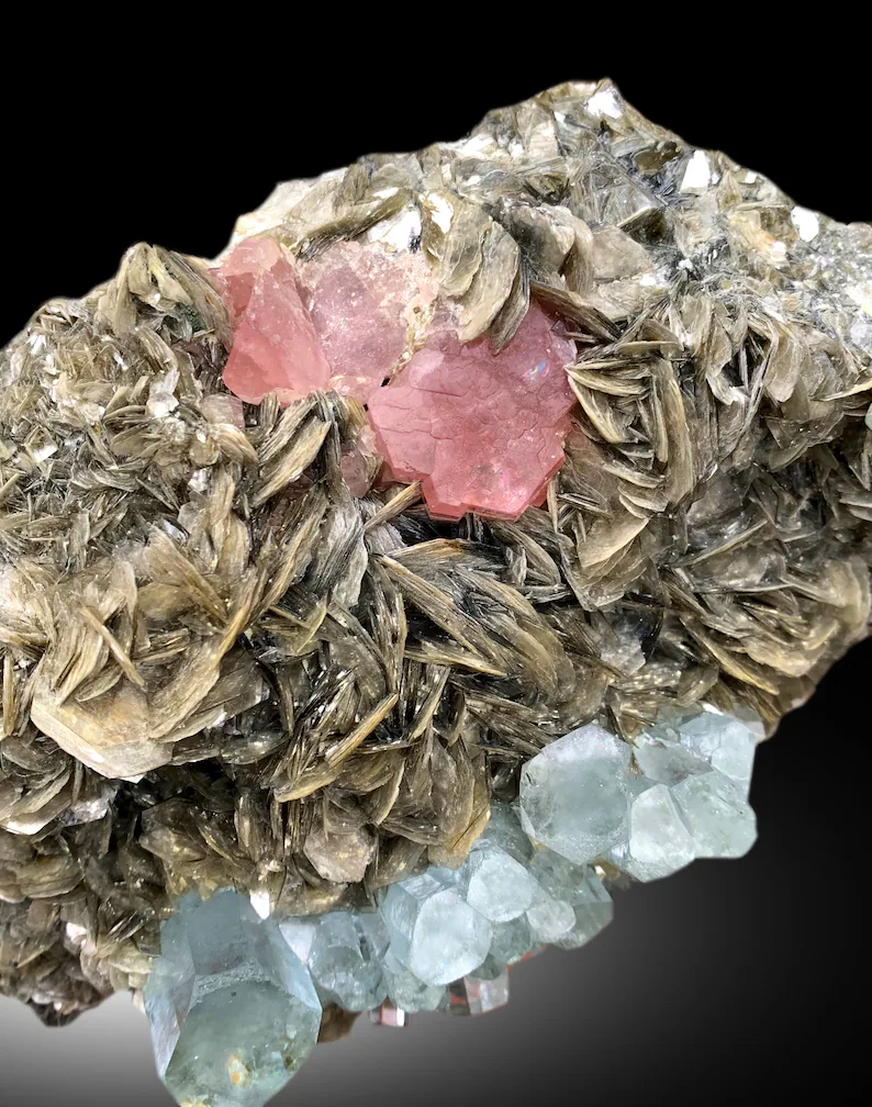 Terminated aquamarine crystals showing natural luster
Pink apatite and aquamarine combo specimen, Pakistan