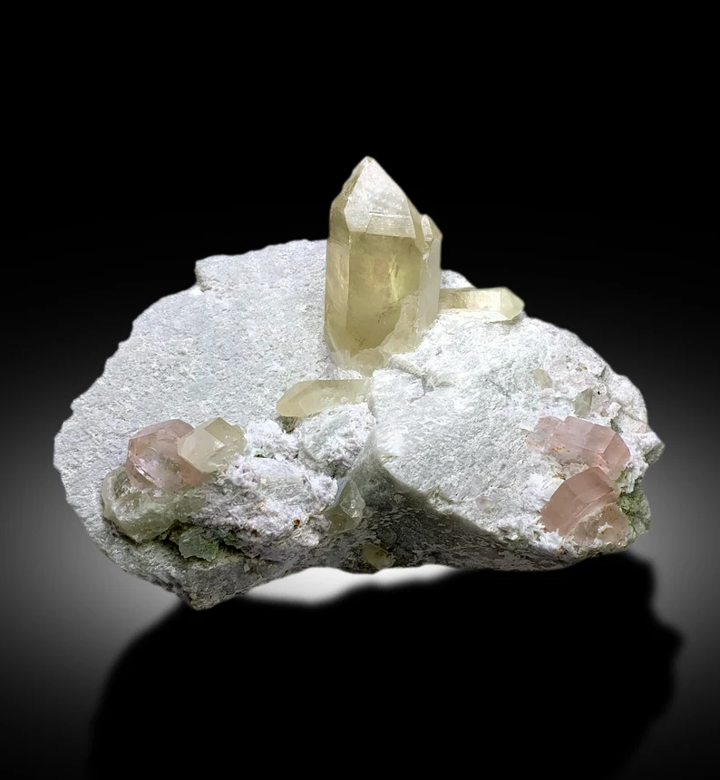 museum grade pink morganite specimen from Afghanistan
morganite and green tourmaline on feldspar