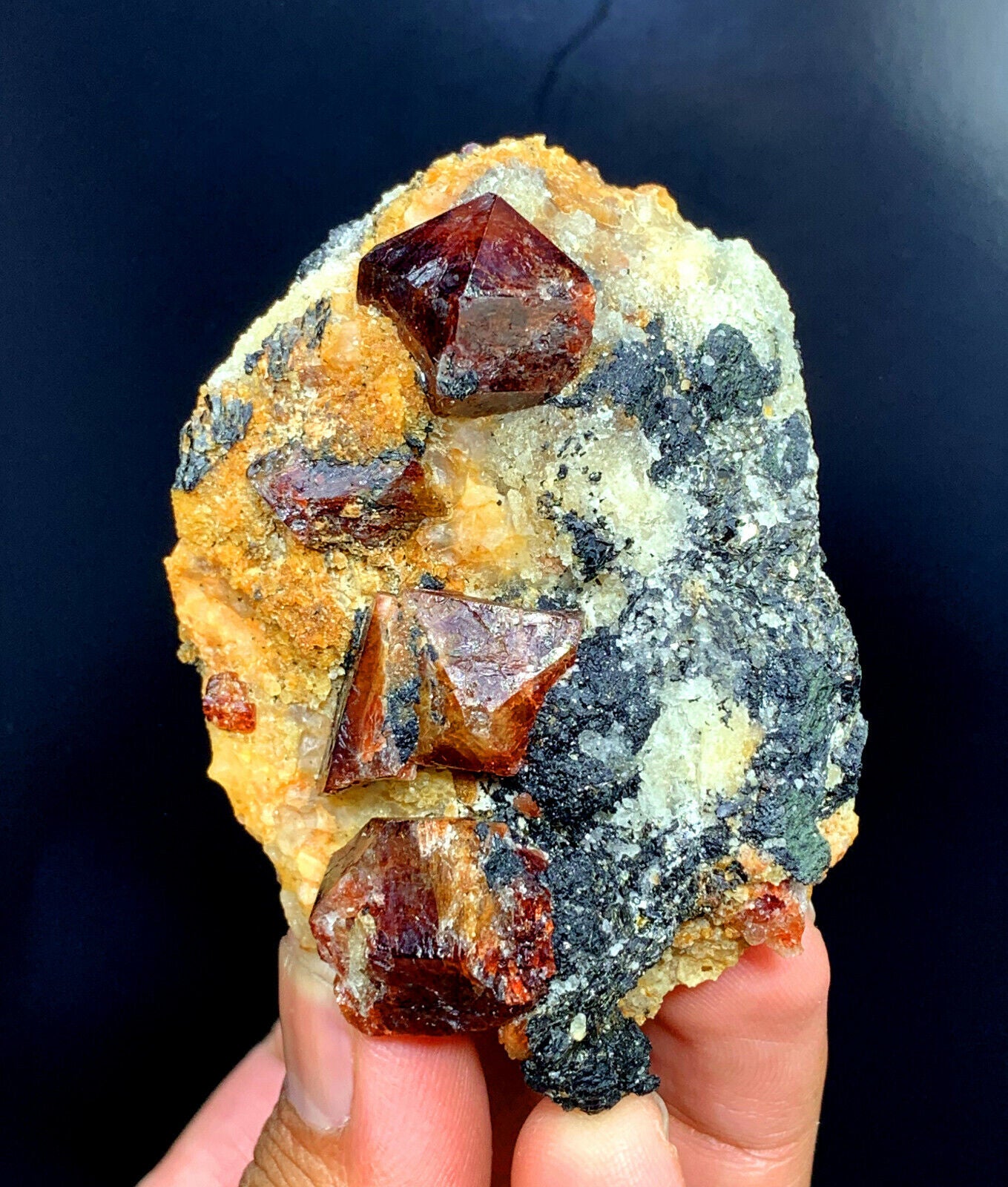 lustrous red zircon crystals on natural matrix
close-up of terminated zircon crystal formation