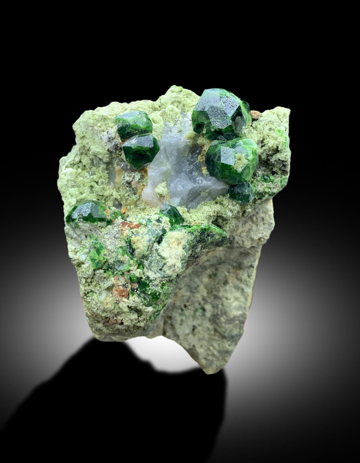 demantoid garnet on calcite display specimen
terminated green garnet crystals on matrix